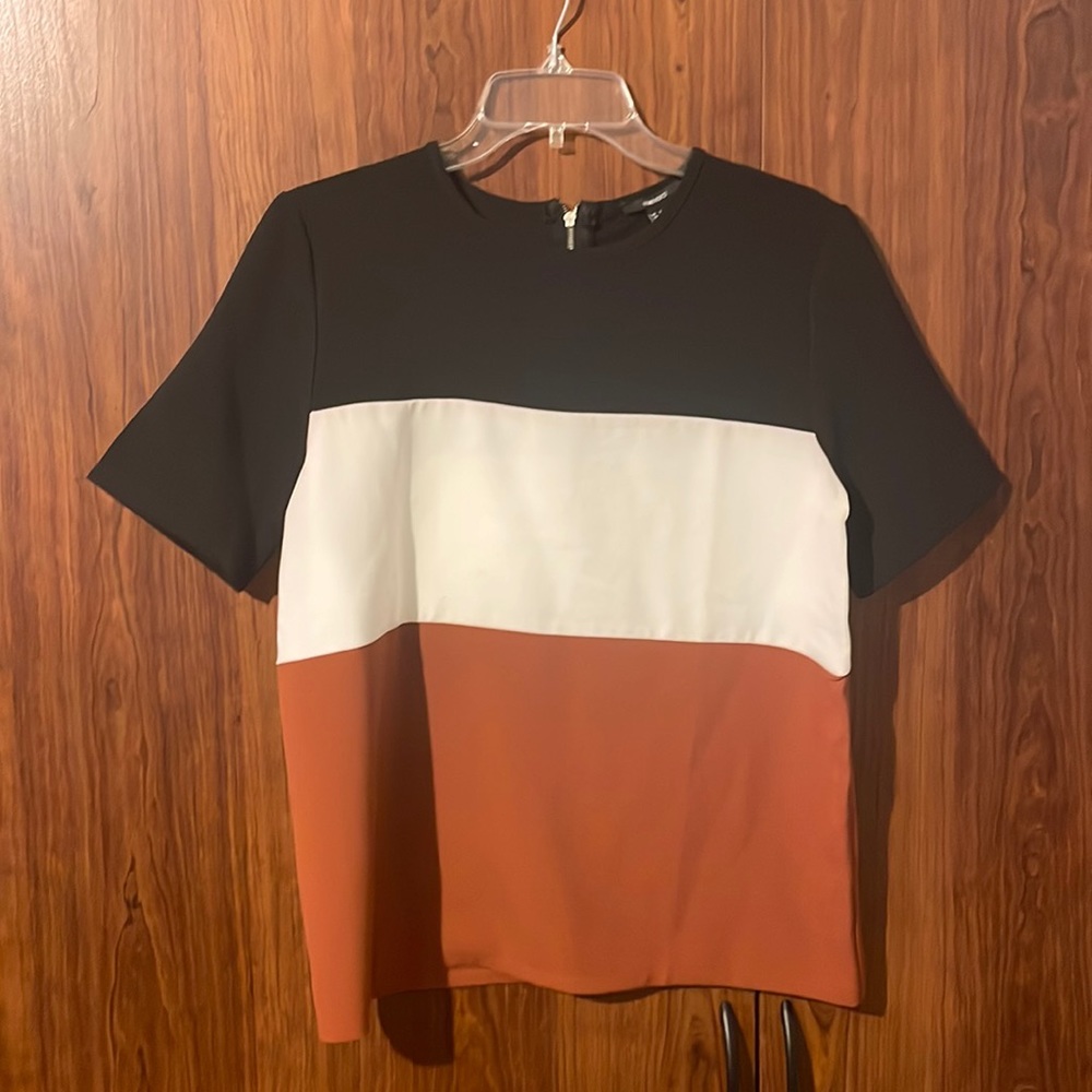 Black, white and burnt orange colored blouse